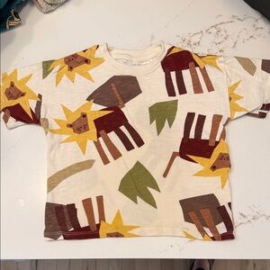 Zara Cream Tee with Lion Graphic and Earth Tone Prints